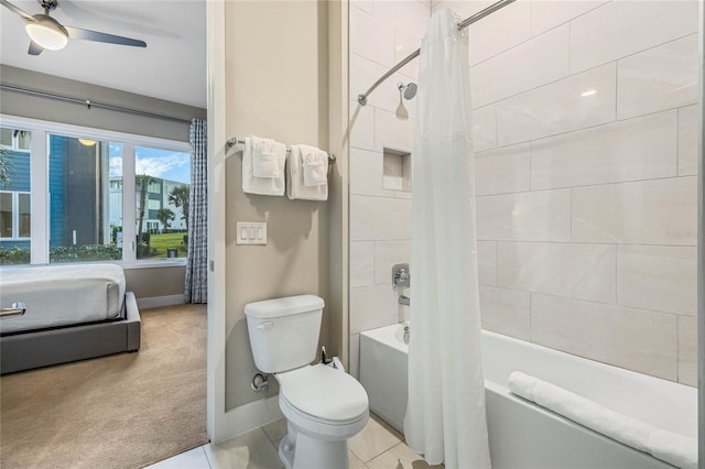 bathroom featuring tile patterned floors, ceiling fan, toilet, and shower / bathtub combination with curtain