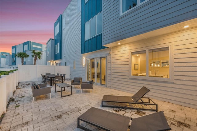 patio terrace at dusk with an outdoor hangout area