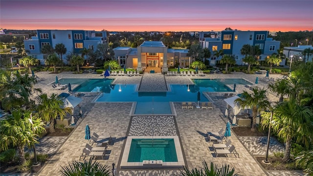 pool at dusk with a patio