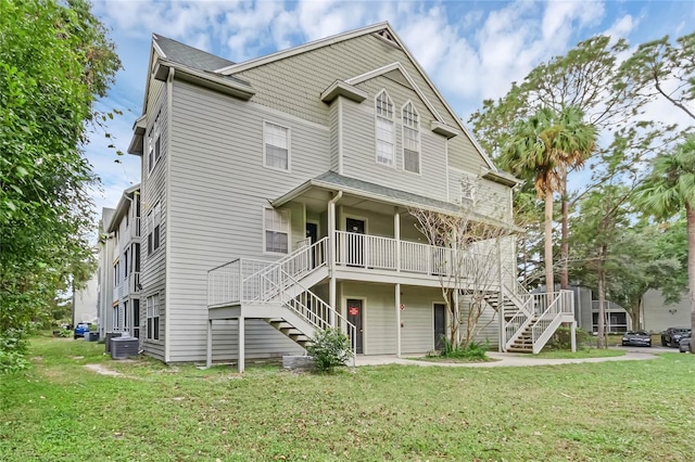 view of front of home with a front yard and cooling unit