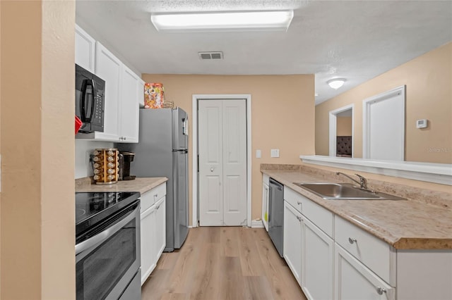 kitchen featuring light hardwood / wood-style floors, stainless steel appliances, sink, and white cabinets