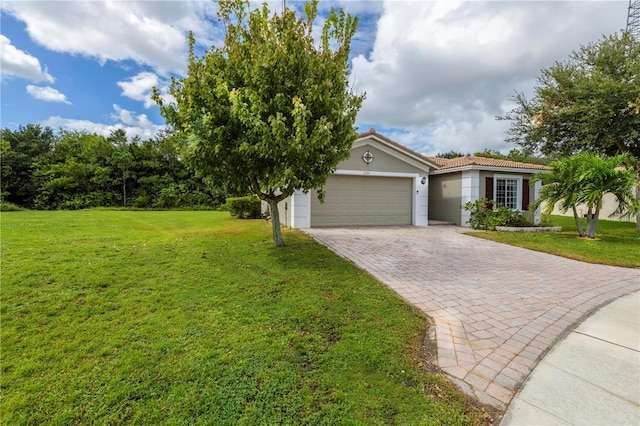 view of front of house with a front yard and a garage