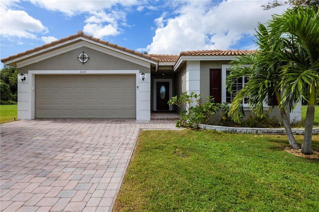 view of front of house featuring a garage and a front lawn