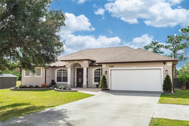 view of front of property with a garage and a front lawn