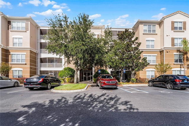 3356 Robert Trent Jones Dr Unit 101, Orlando, FL 32835 - view of building exterior featuring uncovered parking