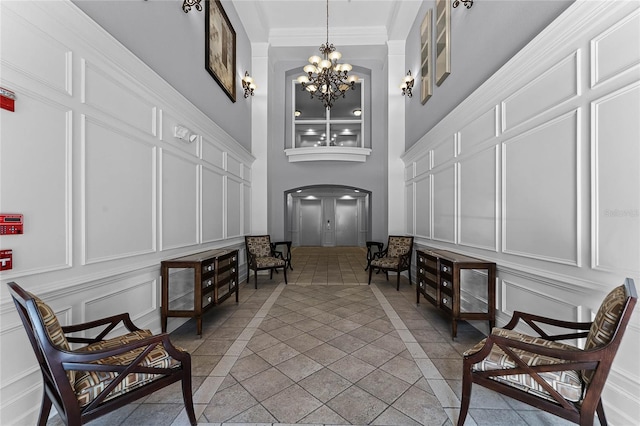 3356 Robert Trent Jones Dr Unit 101, Orlando, FL 32835 - common area with a decorative wall, a towering ceiling, and crown molding