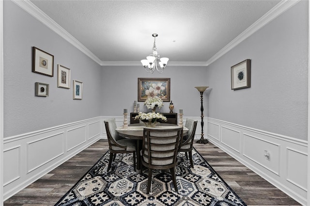 dining space featuring ornamental molding, dark wood-type flooring, and a notable chandelier