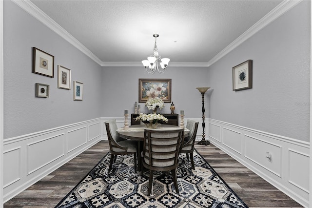 3356 Robert Trent Jones Dr Unit 101, Orlando, FL 32835 - dining room featuring crown molding, a chandelier, dark wood-type flooring, a textured ceiling, and a decorative wall