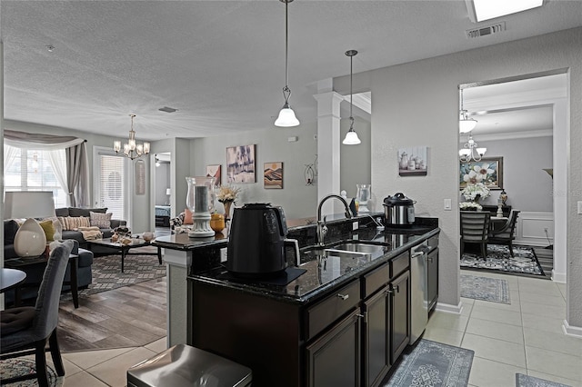 3356 Robert Trent Jones Dr Unit 101, Orlando, FL 32835 - kitchen featuring a chandelier, a sink, light tile patterned floors, a textured ceiling, and dishwasher