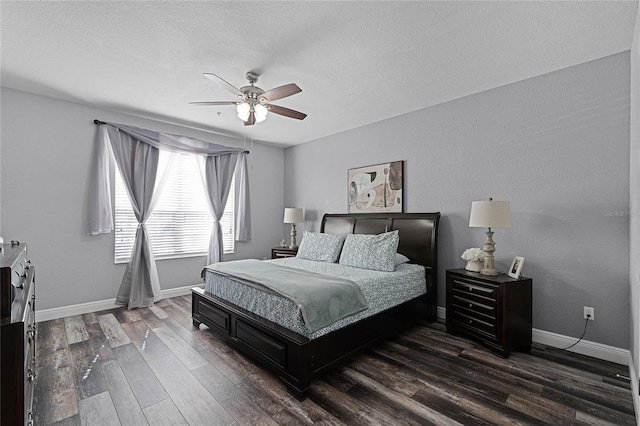 bedroom with dark wood-type flooring, ceiling fan, and a textured ceiling