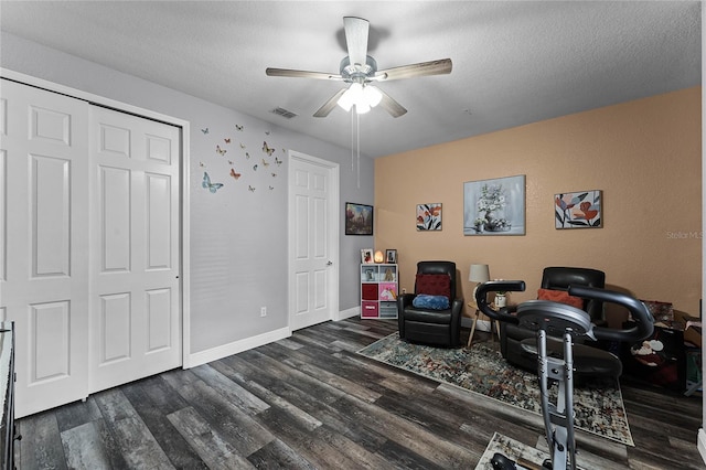 office space featuring dark hardwood / wood-style floors, a textured ceiling, and ceiling fan