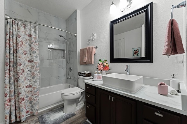 3356 Robert Trent Jones Dr Unit 101, Orlando, FL 32835 - bathroom featuring vanity, shower / bath combo, wood finished floors, toilet, and a textured wall