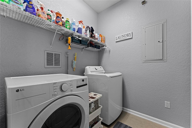3356 Robert Trent Jones Dr Unit 101, Orlando, FL 32835 - laundry room featuring electric panel, washing machine and dryer, tile patterned floors, and baseboards