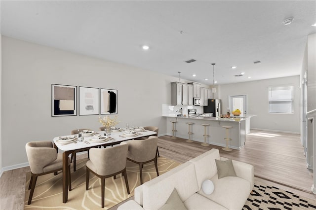 dining space with light hardwood / wood-style flooring