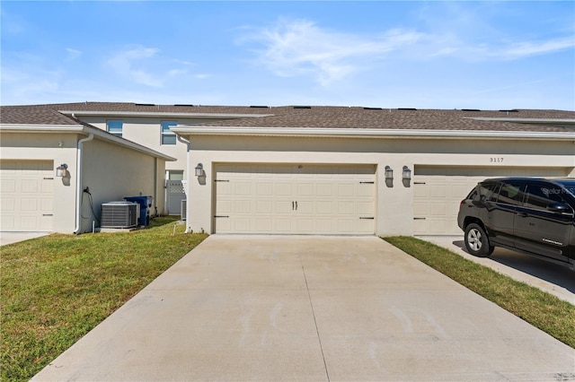 garage featuring cooling unit and a yard