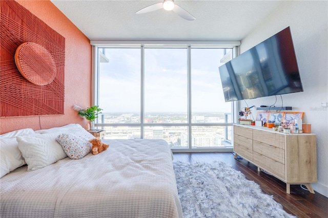 bedroom with a textured ceiling, ceiling fan, dark hardwood / wood-style flooring, and floor to ceiling windows