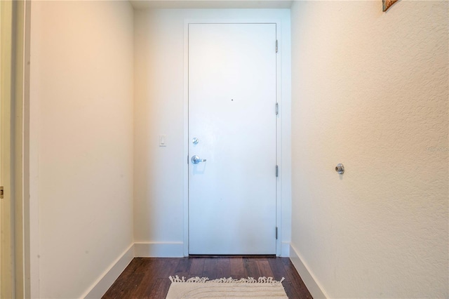 doorway with dark hardwood / wood-style floors