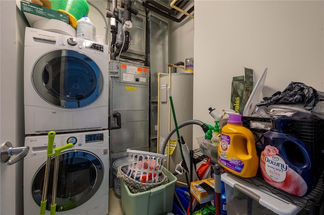 washroom featuring water heater and stacked washer and dryer