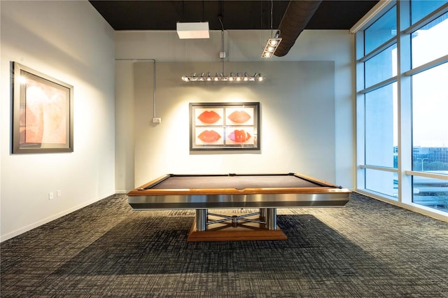 game room featuring a towering ceiling, a wealth of natural light, and carpet floors