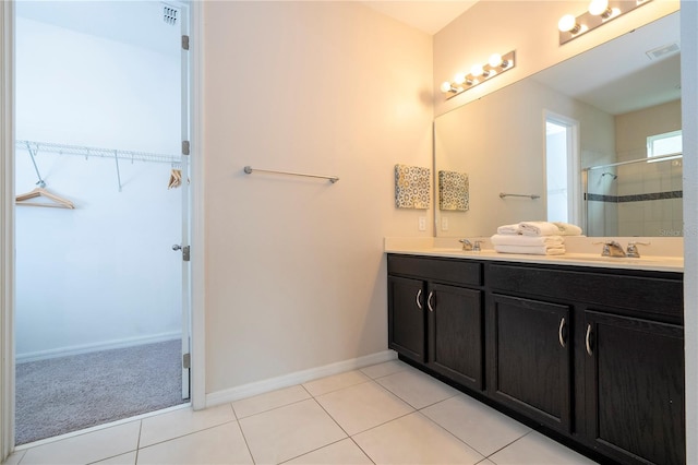 bathroom featuring vanity, tile patterned floors, and a shower with shower door