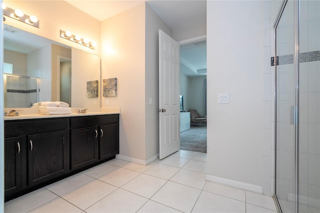 bathroom with vanity, walk in shower, and tile patterned flooring