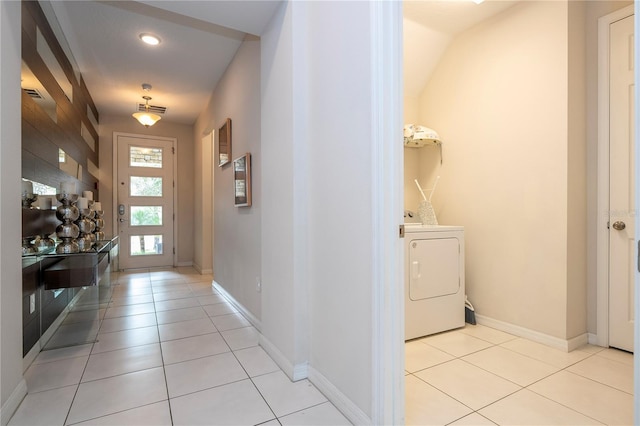 doorway with washer / dryer and light tile patterned floors