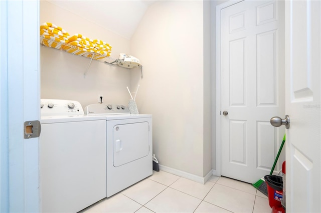 laundry area featuring washing machine and dryer and light tile patterned floors