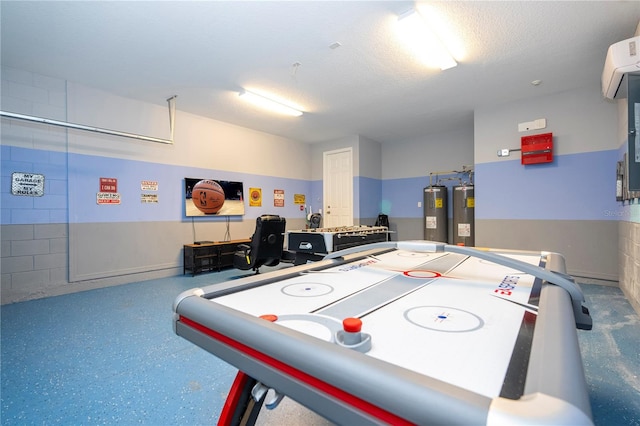 playroom featuring an AC wall unit, water heater, and a textured ceiling