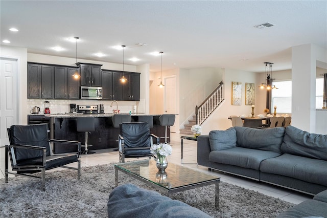 living room with light tile patterned floors and sink