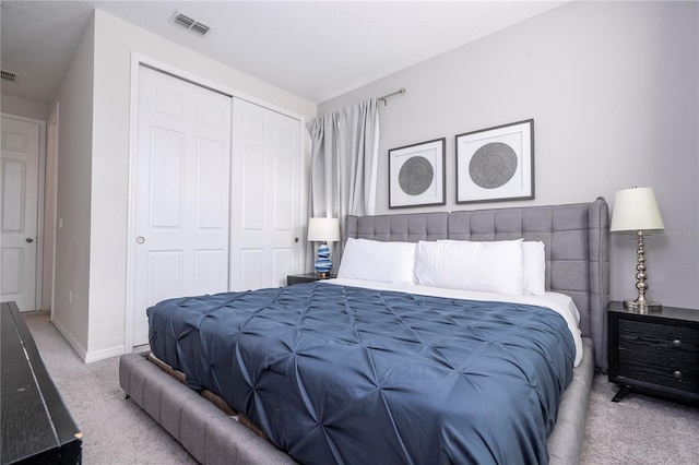 bedroom with light colored carpet and a closet