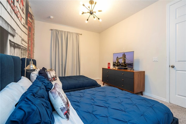 carpeted bedroom featuring a notable chandelier and a textured ceiling