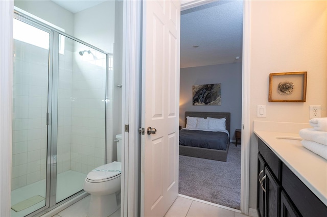 bathroom with toilet, tile patterned flooring, a textured ceiling, an enclosed shower, and vanity