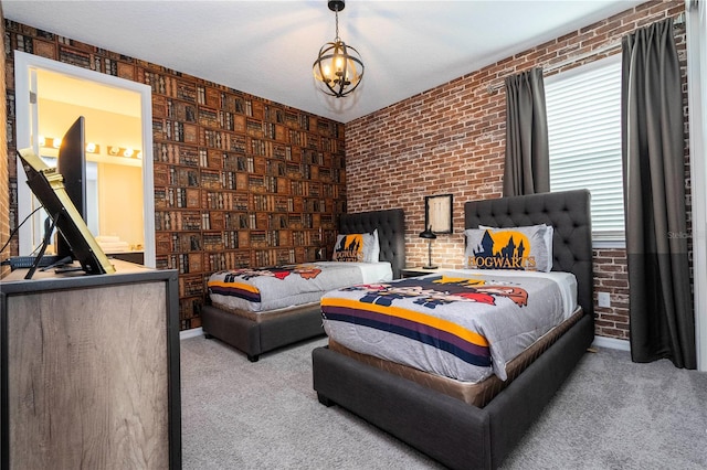 bedroom with ensuite bathroom, light colored carpet, and brick wall