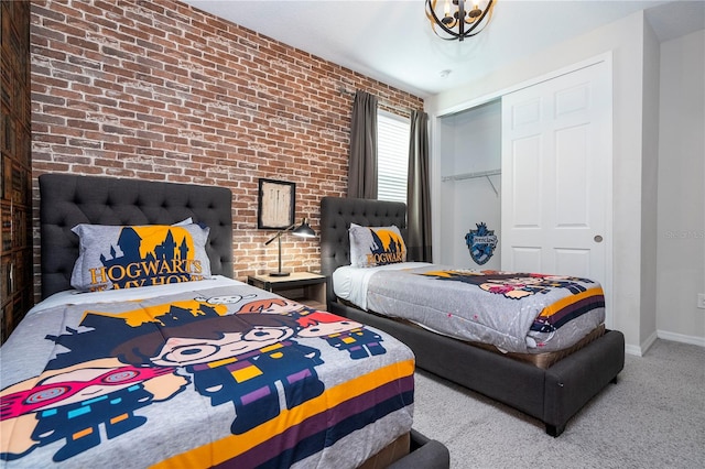 carpeted bedroom featuring a closet and brick wall