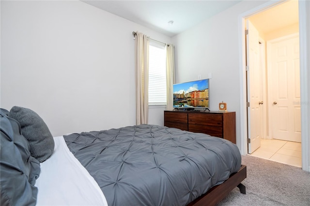 bedroom featuring light carpet