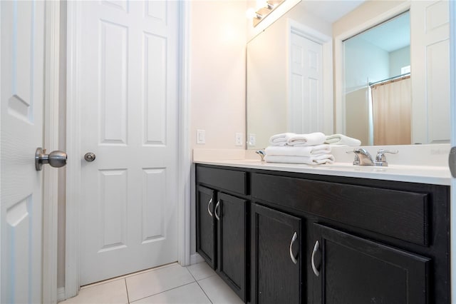 bathroom with curtained shower, vanity, and tile patterned floors