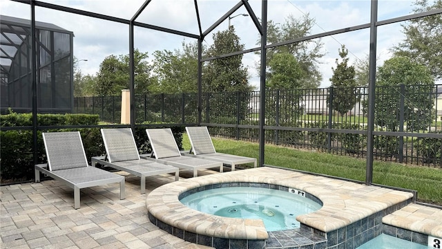 view of patio with glass enclosure and an in ground hot tub