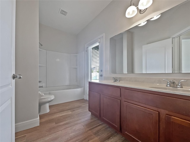 full bathroom with vanity, hardwood / wood-style floors, toilet, and shower / bath combination