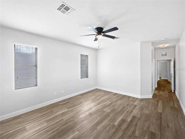 empty room featuring hardwood / wood-style floors and ceiling fan