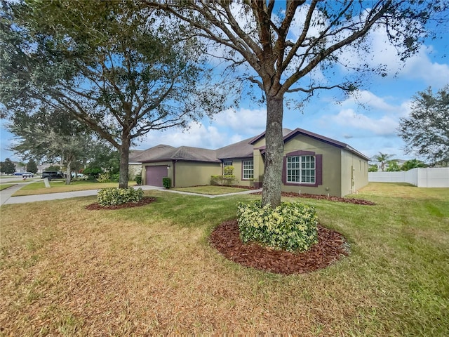 ranch-style home with a garage and a front lawn