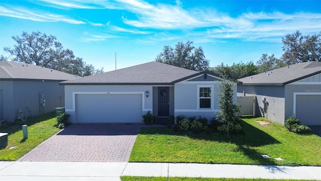 ranch-style house featuring a front yard and a garage