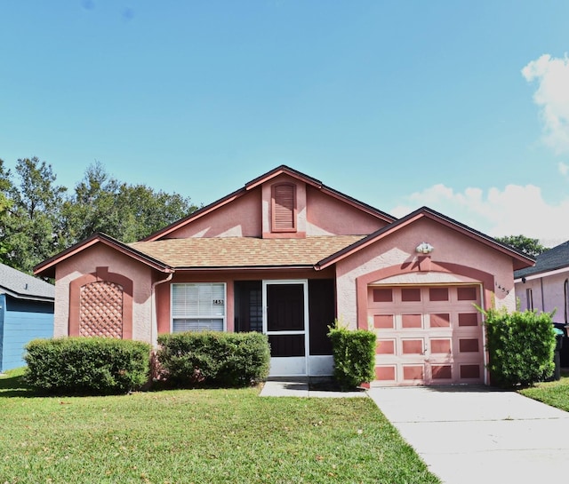 view of front facade with a garage and a front lawn