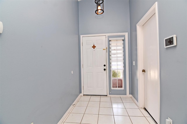 doorway to outside featuring light tile patterned flooring