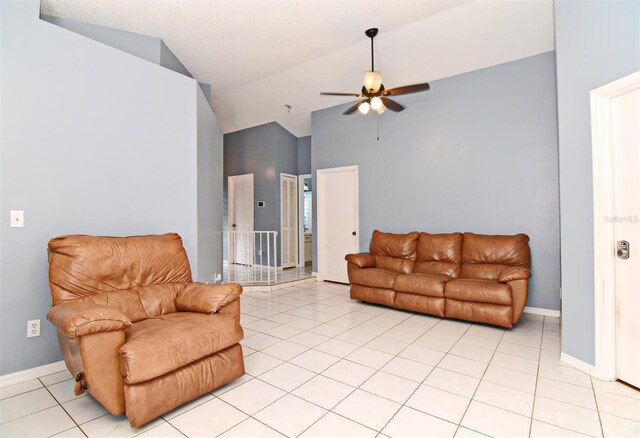 tiled living room with high vaulted ceiling and ceiling fan