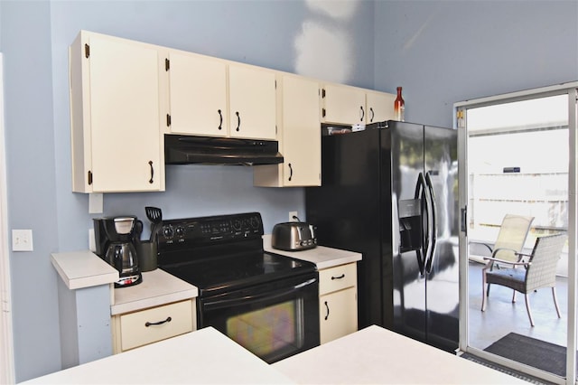 kitchen with cream cabinets and black appliances