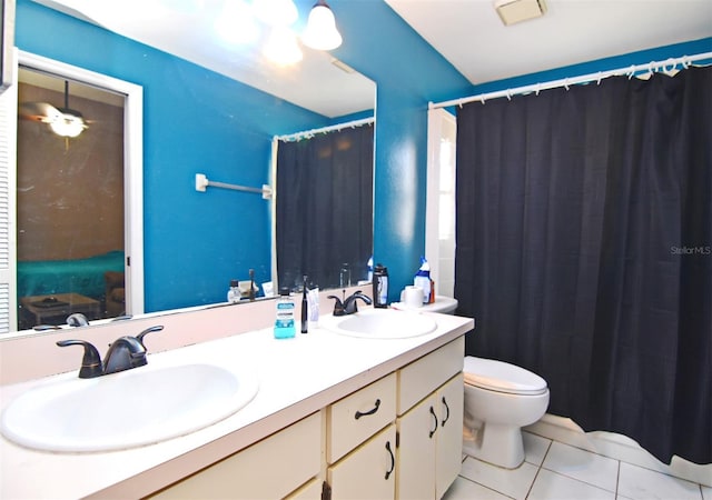 bathroom with walk in shower, vanity, toilet, and tile patterned flooring