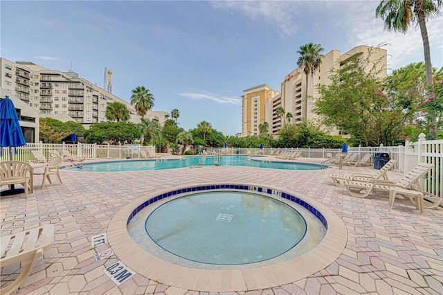 view of pool featuring a community hot tub and a patio area