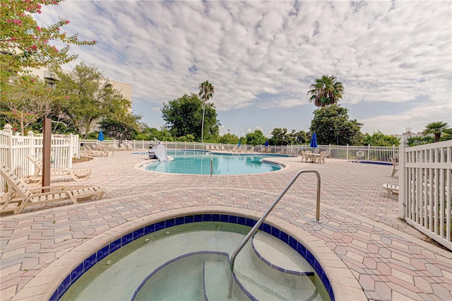 view of pool featuring a patio area and a community hot tub