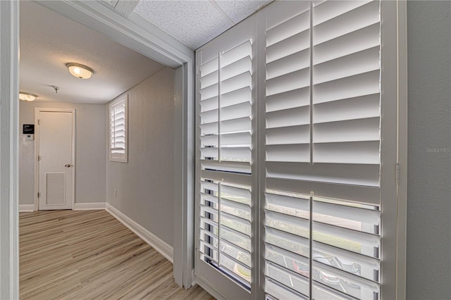 hall with light hardwood / wood-style floors