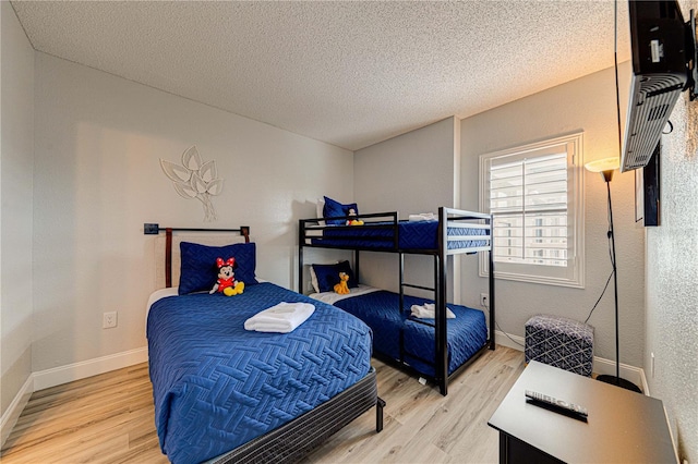 bedroom with wood-type flooring and a textured ceiling